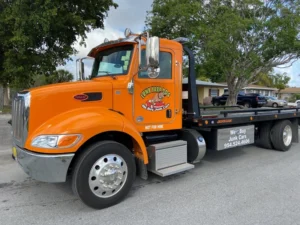 Bright orange tow truck from Junk Yard Dog, a local junk car buyer in Hialeah, FL.